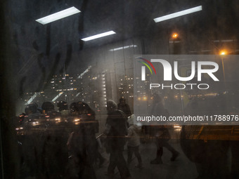 Iranian people walk through a corridor at an urban railway station in western Tehran, Iran, on November 17, 2024. (