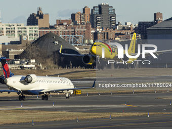 Spirit Airlines Airbus A320NEO aircraft spotted flying for landing at LaGuardia Airport, next to a Delta Air Lines airplane. The iconic yell...