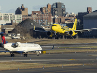 Spirit Airlines Airbus A320NEO aircraft spotted flying for landing at LaGuardia Airport, next to a Delta Air Lines airplane. The iconic yell...