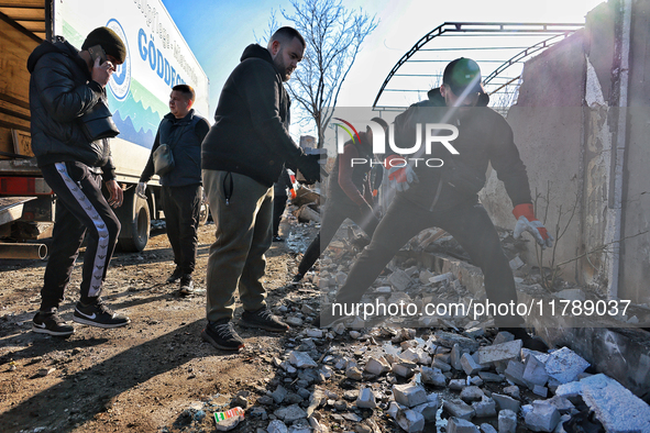 People remove the rubble at a house damaged by a large-scale Russian missile strike in the Odesa region, Ukraine, on November 17, 2024. In t...