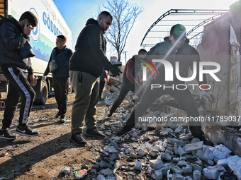 People remove the rubble at a house damaged by a large-scale Russian missile strike in the Odesa region, Ukraine, on November 17, 2024. In t...