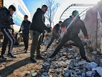 People remove the rubble at a house damaged by a large-scale Russian missile strike in the Odesa region, Ukraine, on November 17, 2024. In t...