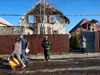 A firefighter stands among people in the street outside a house damaged by a large-scale Russian missile strike in the Odesa region, Ukraine...