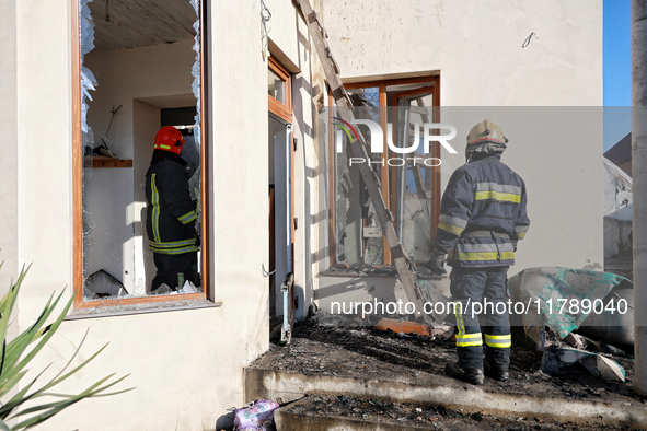 Firefighters work at a house damaged by a large-scale Russian missile strike in the Odesa region, southern Ukraine, on November 17, 2024. In...