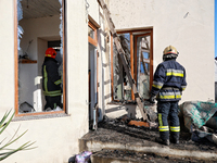 Firefighters work at a house damaged by a large-scale Russian missile strike in the Odesa region, southern Ukraine, on November 17, 2024. In...