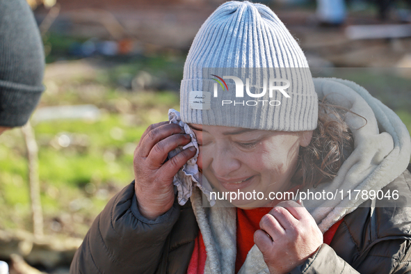 A woman wipes her tears with a handkerchief after a large-scale Russian missile strike in the Odesa region, Ukraine, on November 17, 2024. I...