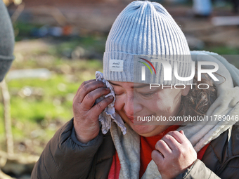 A woman wipes her tears with a handkerchief after a large-scale Russian missile strike in the Odesa region, Ukraine, on November 17, 2024. I...