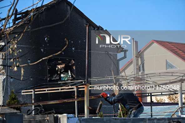 A welder works near a house damaged by a large-scale Russian missile strike in the Odesa region, Ukraine, on November 17, 2024. In the recen...