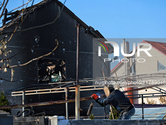 A welder works near a house damaged by a large-scale Russian missile strike in the Odesa region, Ukraine, on November 17, 2024. In the recen...