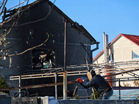 A welder works near a house damaged by a large-scale Russian missile strike in the Odesa region, Ukraine, on November 17, 2024. In the recen...