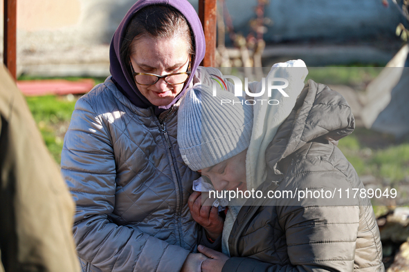 A woman cries as she is hugged after a large-scale Russian missile strike in the Odesa region, Ukraine, on November 17, 2024. In the recent...