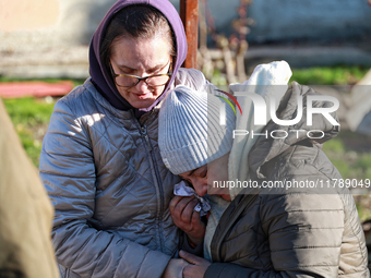 A woman cries as she is hugged after a large-scale Russian missile strike in the Odesa region, Ukraine, on November 17, 2024. In the recent...