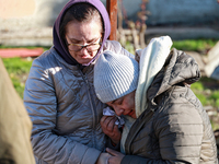 A woman cries as she is hugged after a large-scale Russian missile strike in the Odesa region, Ukraine, on November 17, 2024. In the recent...