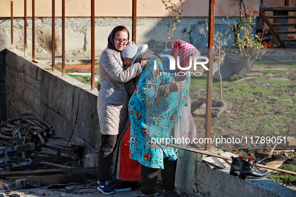 Women who survive a large-scale Russian missile strike stand among the debris in the Odesa region, Ukraine, on November 17, 2024. In the rec...