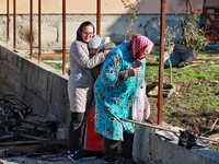 Women who survive a large-scale Russian missile strike stand among the debris in the Odesa region, Ukraine, on November 17, 2024. In the rec...