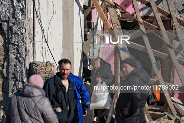 A woman carries a bag with belongings salvaged from a house destroyed by a large-scale Russian missile strike in the Odesa region, Ukraine,...