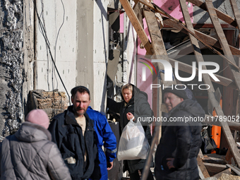 A woman carries a bag with belongings salvaged from a house destroyed by a large-scale Russian missile strike in the Odesa region, Ukraine,...