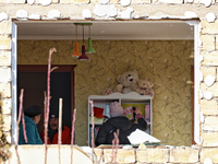 In the Odesa region, Ukraine, on November 17, 2024, people are in a child's room as seen through a window knocked out by a large-scale Russi...