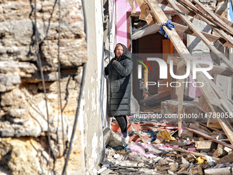 A woman stands outside a house damaged by a large-scale Russian missile strike in the Odesa region, Ukraine, on November 17, 2024. In the re...