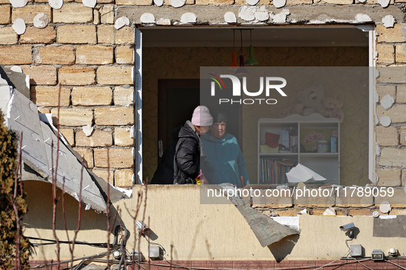 Two women are in a room as seen through a window knocked out by a large-scale Russian missile strike in Odesa region, Ukraine, on November 1...