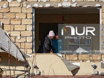 Two women are in a room as seen through a window knocked out by a large-scale Russian missile strike in Odesa region, Ukraine, on November 1...