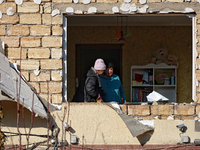 Two women are in a room as seen through a window knocked out by a large-scale Russian missile strike in Odesa region, Ukraine, on November 1...