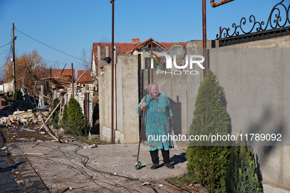 An elderly woman stands at the gate of a house damaged by a large-scale Russian missile strike in the Odesa region, Ukraine, on November 17,...