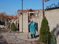 An elderly woman stands at the gate of a house damaged by a large-scale Russian missile strike in the Odesa region, Ukraine, on November 17,...