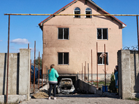 A woman faces a house damaged by a large-scale Russian missile strike in the Odesa region, Ukraine, on November 17, 2024. In the recent mass...