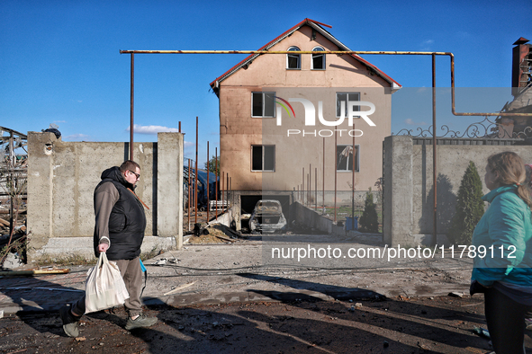 A man and a woman stand outside a house damaged by a large-scale Russian missile strike in the Odesa region, Ukraine, on November 17, 2024....