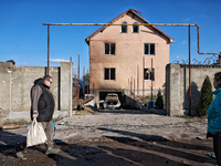 A man and a woman stand outside a house damaged by a large-scale Russian missile strike in the Odesa region, Ukraine, on November 17, 2024....