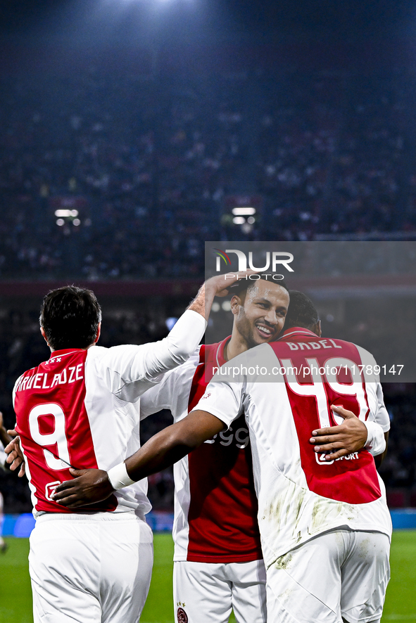 Supporters of AFC Ajax Amsterdam, along with AFC Ajax Amsterdam legend players Ryan Babel and Ricardo van Rhijn, celebrate a goal during the...