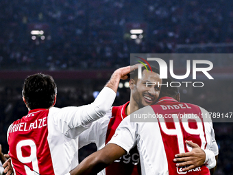 Supporters of AFC Ajax Amsterdam, along with AFC Ajax Amsterdam legend players Ryan Babel and Ricardo van Rhijn, celebrate a goal during the...