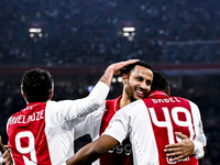 Supporters of AFC Ajax Amsterdam, along with AFC Ajax Amsterdam legend players Ryan Babel and Ricardo van Rhijn, celebrate a goal during the...