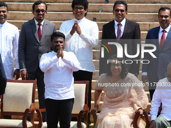 Sri Lankan President Anura Kumara Dissanayake acknowledges the supporters as Prime Minister Harini Amarasuriya looks on with newly appointed...