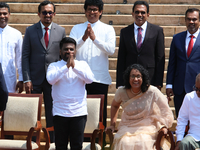 Sri Lankan President Anura Kumara Dissanayake acknowledges the supporters as Prime Minister Harini Amarasuriya looks on with newly appointed...