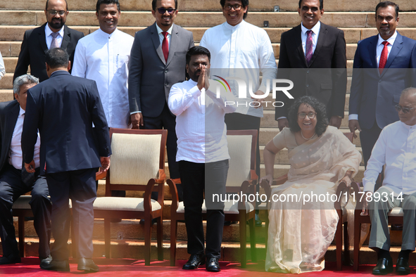 Sri Lankan President Anura Kumara Dissanayake acknowledges the supporters as Prime Minister Harini Amarasuriya looks on with newly appointed...