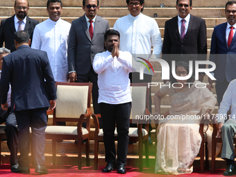 Sri Lankan President Anura Kumara Dissanayake acknowledges the supporters as Prime Minister Harini Amarasuriya looks on with newly appointed...