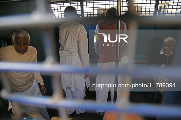 Former ministers and leaders of the Bangladesh Awami League party look on from a police vehicle outside Bangladesh's International Crimes Tr...