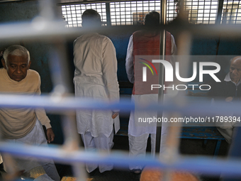 Former ministers and leaders of the Bangladesh Awami League party look on from a police vehicle outside Bangladesh's International Crimes Tr...