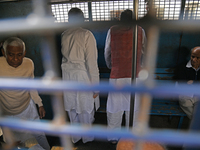 Former ministers and leaders of the Bangladesh Awami League party look on from a police vehicle outside Bangladesh's International Crimes Tr...