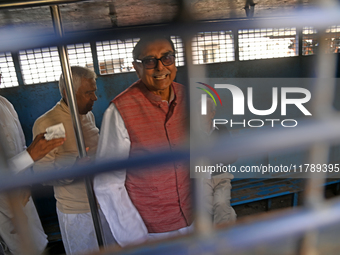 Former ministers and leaders of the Bangladesh Awami League party look on from a police vehicle outside Bangladesh's International Crimes Tr...