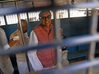 Former ministers and leaders of the Bangladesh Awami League party look on from a police vehicle outside Bangladesh's International Crimes Tr...