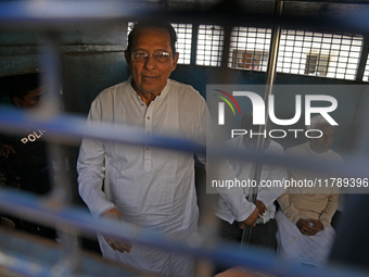 Former ministers and leaders of the Bangladesh Awami League party look on from a police vehicle outside Bangladesh's International Crimes Tr...