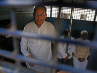 Former ministers and leaders of the Bangladesh Awami League party look on from a police vehicle outside Bangladesh's International Crimes Tr...