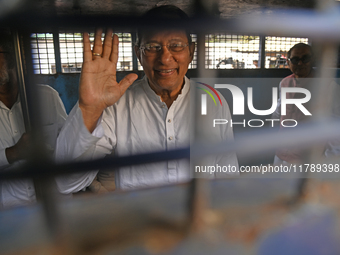 Former ministers and leaders of the Bangladesh Awami League party look on from a police vehicle outside Bangladesh's International Crimes Tr...