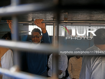 Former ministers and leaders of the Bangladesh Awami League party look on from a police vehicle outside Bangladesh's International Crimes Tr...