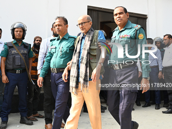 Police personnel escort detainee Dr. Taufiq-e-Ilahi Chowdhury, adviser to former Prime Minister Sheikh Hasina, former Minister, and a member...