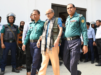 Police personnel escort detainee Dr. Taufiq-e-Ilahi Chowdhury, adviser to former Prime Minister Sheikh Hasina, former Minister, and a member...