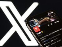 An editorial image shows an iPhone screen with Tesla's account displayed on the X social network platform.  (